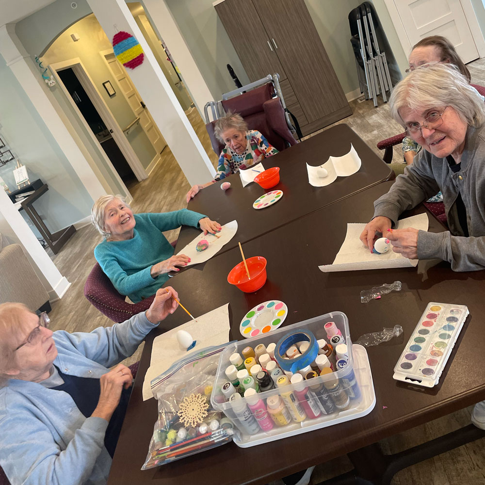 RSL Memory Care of New Berlin, WI decorating Easter eggs