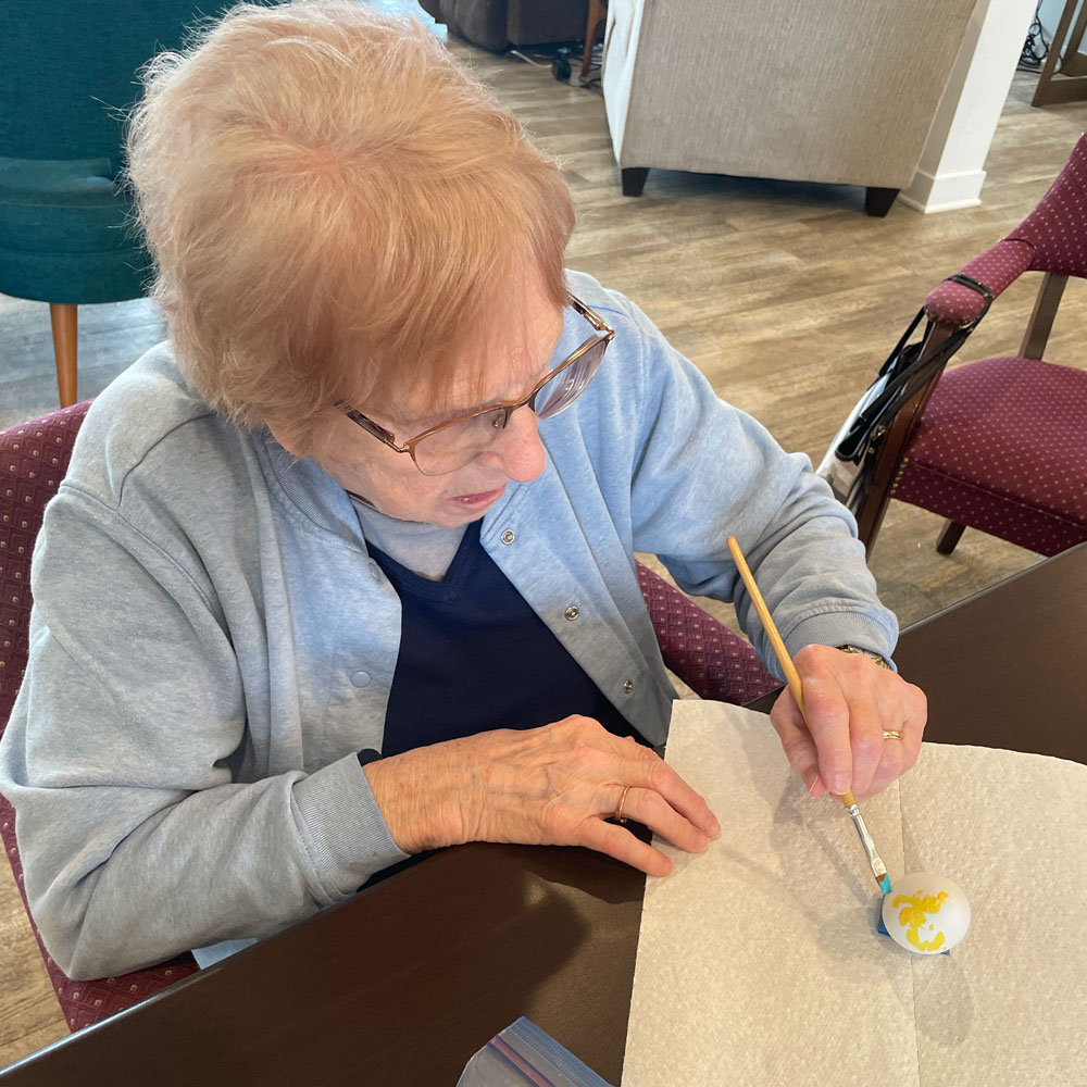 RSL Memory Care of New Berlin, WI decorating Easter eggs